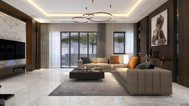 Mẫu trang trí nội thất phòng khách biệt thự đẹp sang trọng cao cấp nổi bật với chất liệu gỗ công nghiệp An Cường, bộ sofa góc nâu cùng chiếc bàn khối vuông lạ mắt.